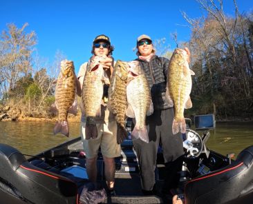Cole Sands and fishing partner with four smallmouth bass