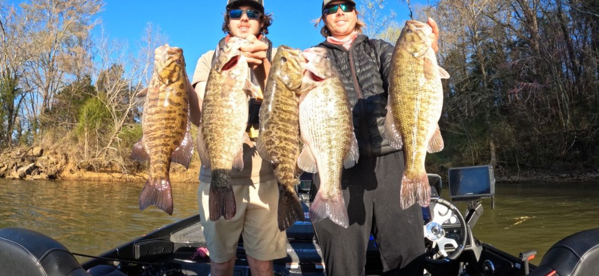 Cole Sands and fishing partner with four smallmouth bass