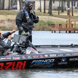 Cole Sands landing a bass during a Elite Series event with a Witch Doctor Tackle rod.