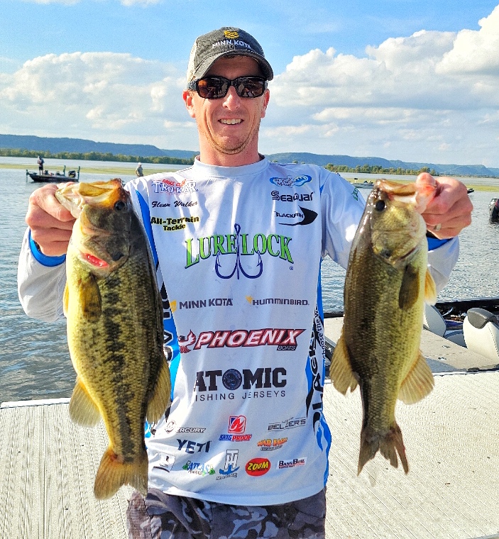 Glenn Walker with two topwater bass from a BFL