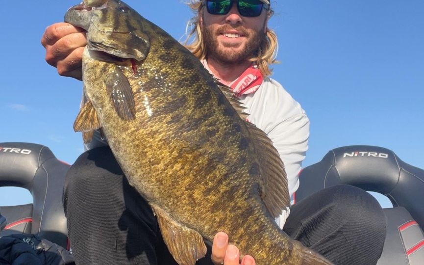 Cole Sands holding up smallmouth bass from the St. Lawrence River.