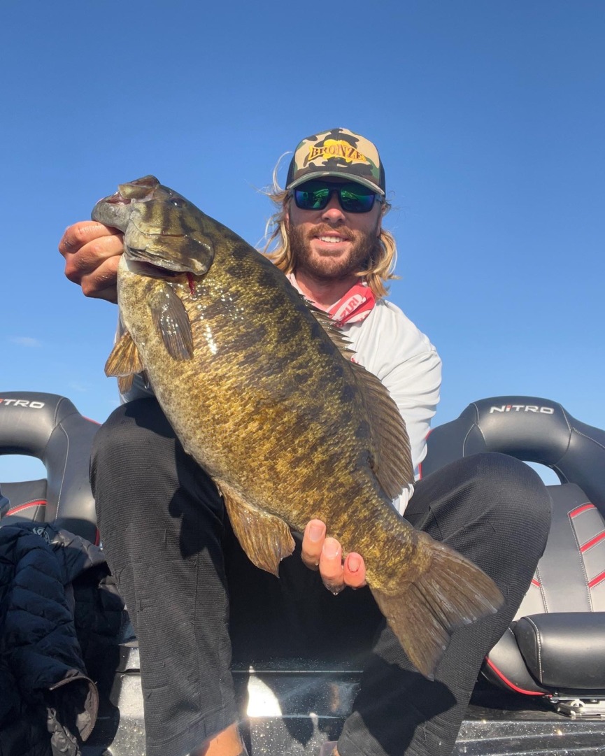 Cole Sands holding up smallmouth bass from the St. Lawrence River.