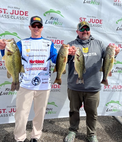 Glenn Walker and Jeremiah Shaver holding four Mississippi River bass from their day one limit.